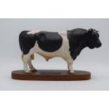 Beswick Friesian Bull A2580 on wooden base. In good condition, slight grazes to paintwork on both