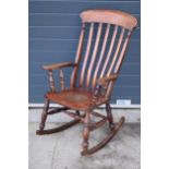 19th century elm/ash rocking chair with arm supports, 109cm tall. In good condition, some old worm