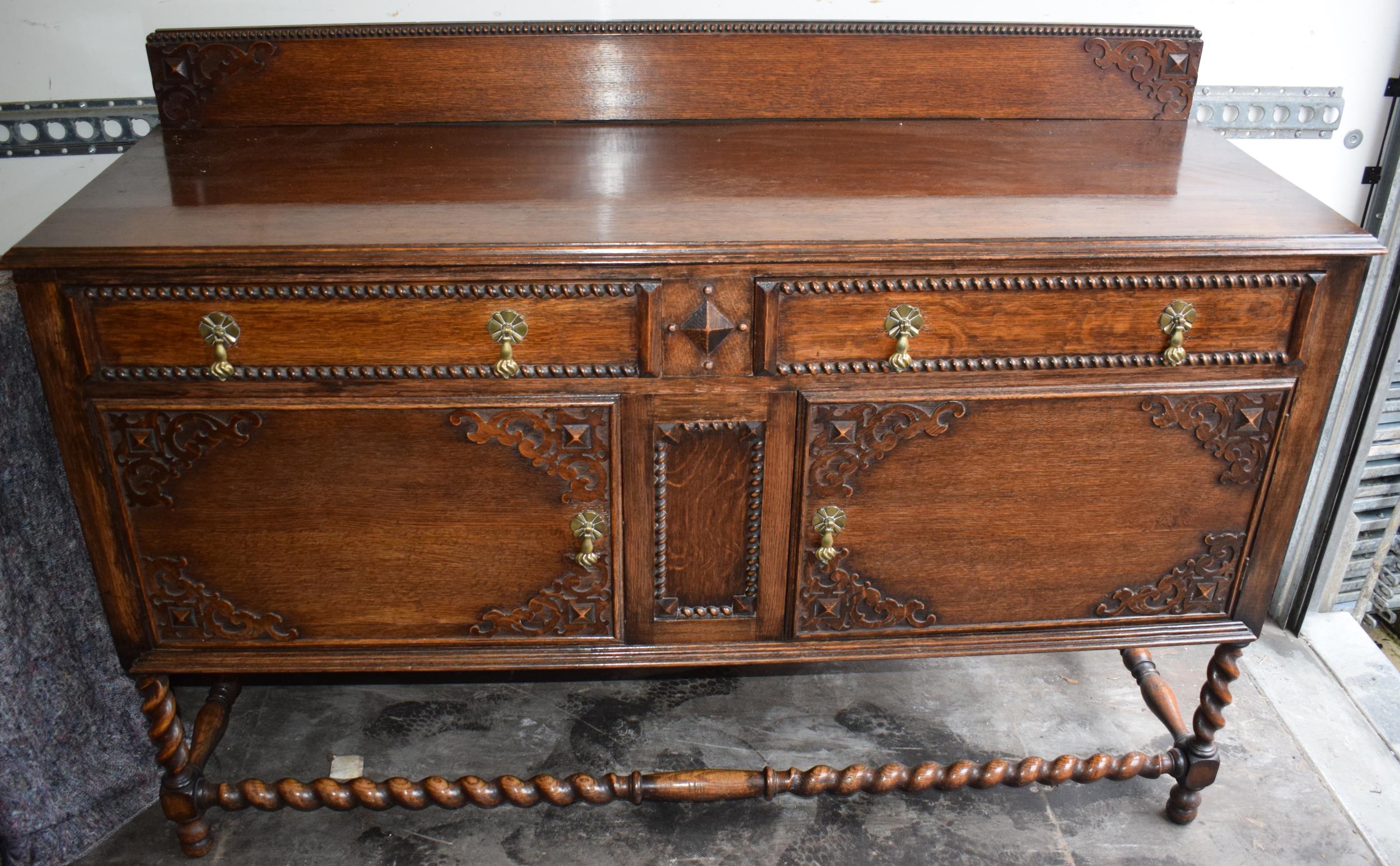 1930s oak sideboard with carved decoration with drawers and cupboards, 153x51x107cm tall. In good