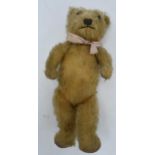 Vintage mid 20th century teddy bear with articulated joints and glass eyes, 31cm tall. Lost some