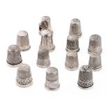 A collection of silver thimbles to include a set of three with etched star, by Henry Griffiths and