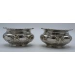 A pair of silver table salts with embossed decoration of a bow and similar, London 1897, 80.4 grams,