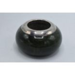 Green hardstone match holder and striker with silver rim, Birmingham 1901, 6cm diameter.