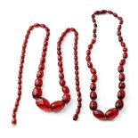 A pair of vintage bakelite cherry amber (or similar) graduated necklaces with faceted beads, longest