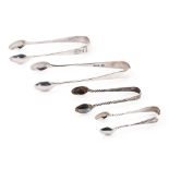 A collection of hallmarked silver sugar tongs to include a plain pair and others with ornate