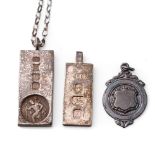 A pair of silver ingots, one on chain, together with a silver fob, 59.8 grams (3).