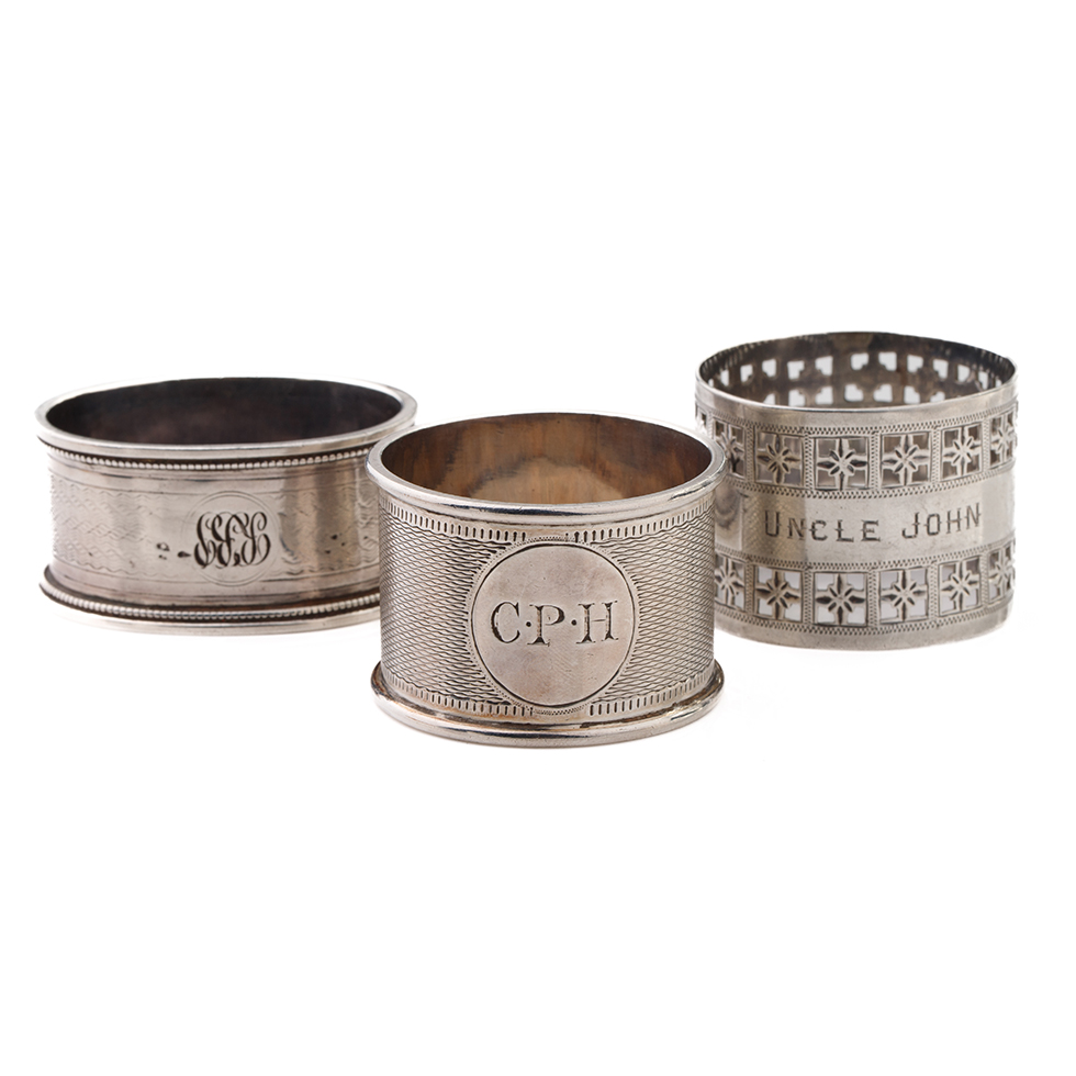 A trio of silver napkin rings of varying designs to include Martin, Hall & Co Sheffield 1881,