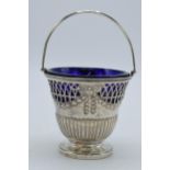 Silver sugar basket with blue glass liner, London 1896 'CR', 100.4 grams, 12.5cm tall.