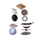 A collection of silver brooches to include a silver gilt Indian brooch, a Scandinavian examples