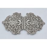 Silver ornate belt buckle with figural design, London 1985, 75.8 grams, 12cm wide.