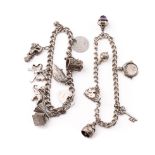 A pair of silver charm bracelets with charms to include a car, a tankard, a hedgehog and others,