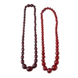 A pair of vintage bakelite cherry amber (or similar) graduated necklaces with faceted beads, each