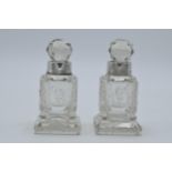 A pair of silver collared glass perfume bottles, Birmingham 1908, H C Davis, 10cm tall (2).