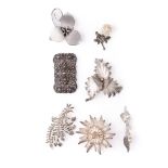 A collection of silver brooches to mainly consist of floral designs to include marcasite and