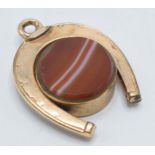 Gold plated horseshoe watch fob with agate face and compass, 3.5cm long.