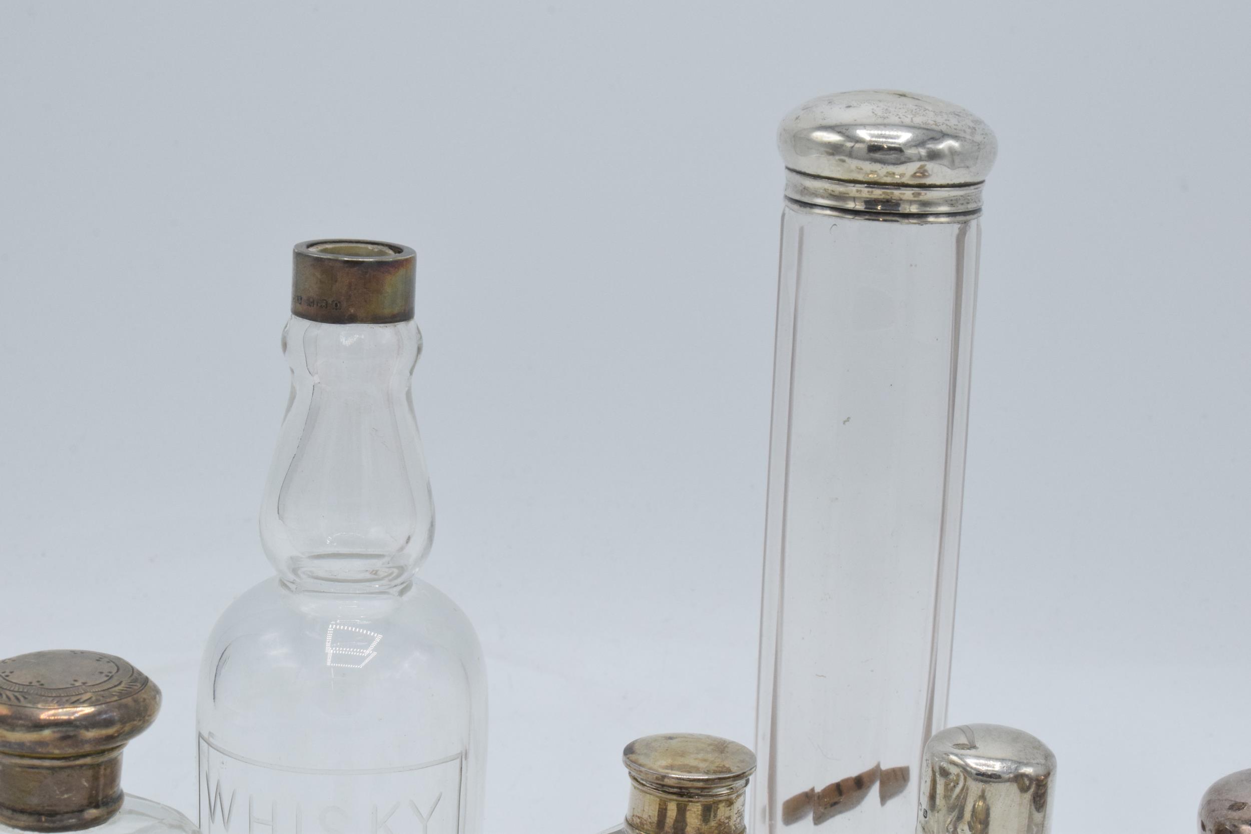 A collection of hallmarked silver topped glass containers to include cruets, perfume and others ( - Image 5 of 5