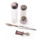 A trio of silver topped scent bottles together with silver handled knife and a medal with a silver