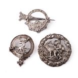 A large silver 830s Scandinavian brooch with traditional scenes together with a Scottish deer brooch