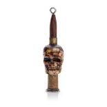 Vintage Trench Art of a carved bone in the form of a skull with an ammunition shell, 9cm tall,