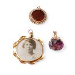 A trio of 9ct gold items to include a gold framed locket, and 2 watch fobs, one with bloodstone, the