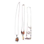 A trio of silver ladies necklaces with pendants to include amber-style items and amethyst coloured