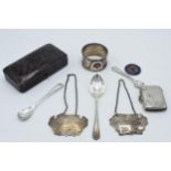 A collection of silver items to include a silver vesta, Birmingham 1920, silver decanter labels