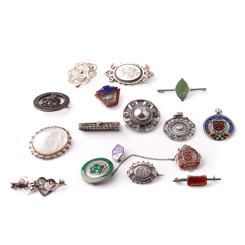 An interesting collection of silver jewellery to include enamelled fobs, Victorian brooches,