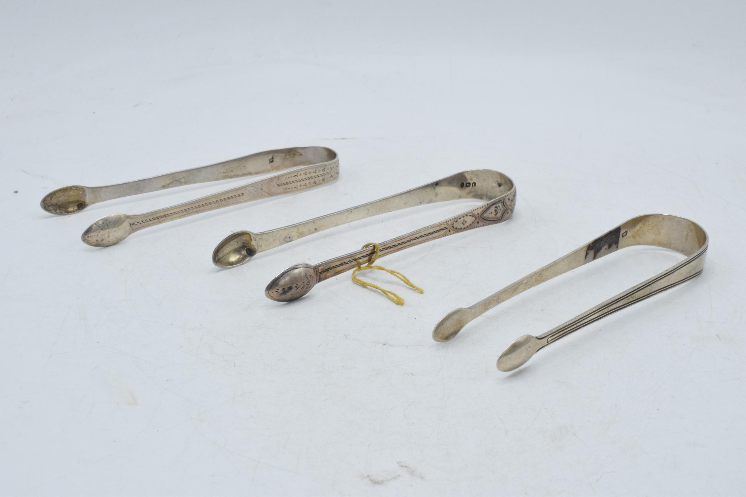 A trio of Georgian sugar tongs, one with bright cut decoration and 2 similar, 92.7 grams (3). - Image 2 of 5