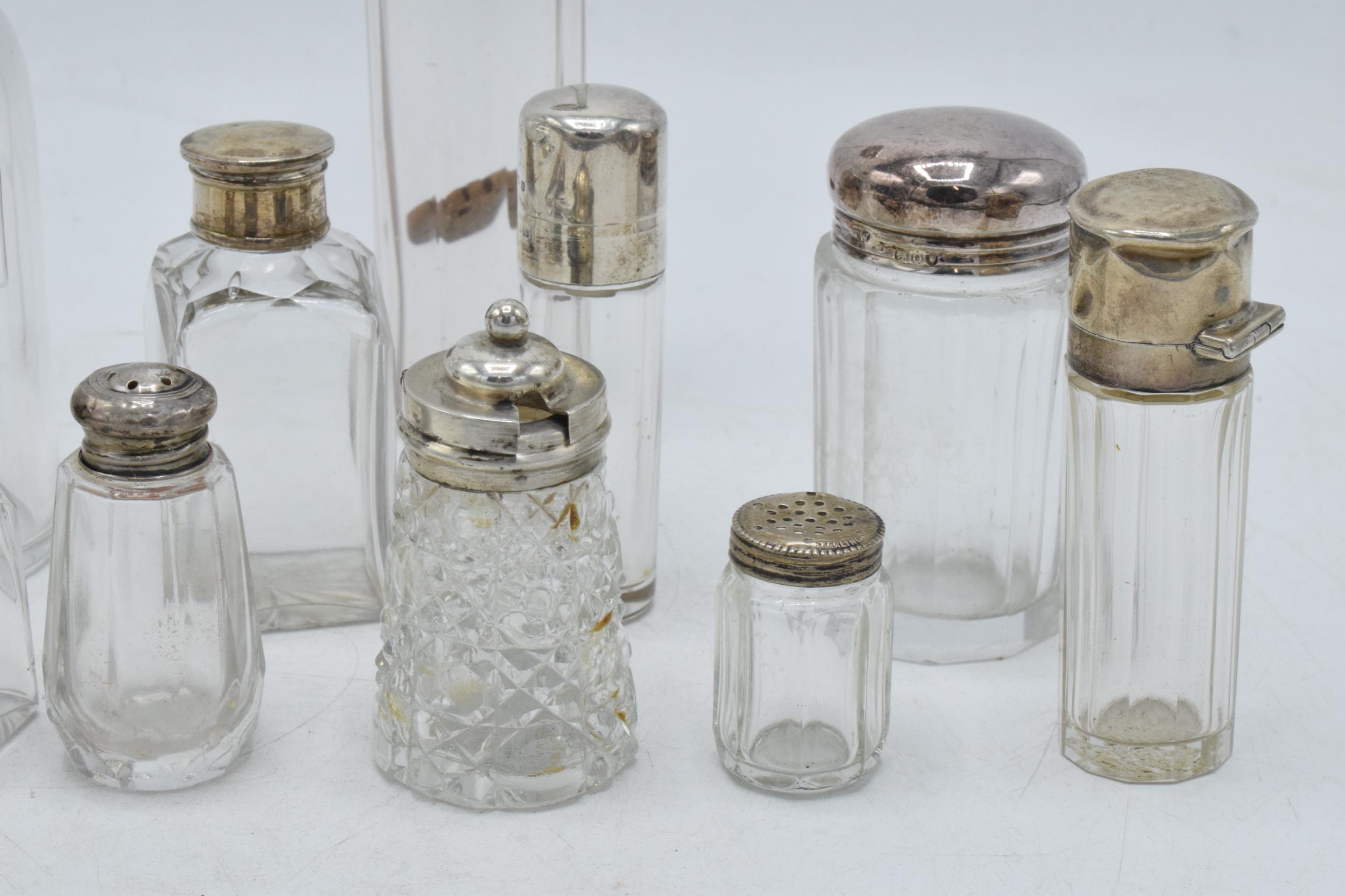 A collection of hallmarked silver topped glass containers to include cruets, perfume and others ( - Image 3 of 5