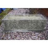 Reconstituted stone garden trough / planter with ornate design, 73x27x27cm tall.