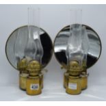 A pair of wall mounted oil lamps with magnifying mirror back lenses. Scratch built by a skilled