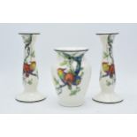 Crown Ducal decorated with parrots amongst foliage to include a pair of candlesticks and a vase (3),