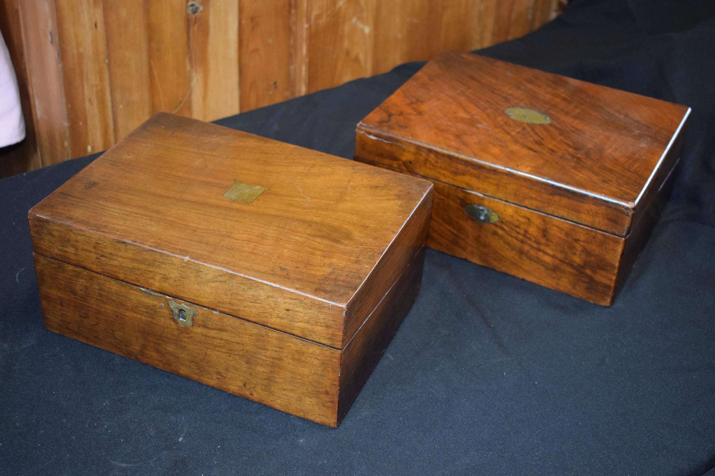 A pair of 19th century wooden writing slopes with brass escutcheons (2).