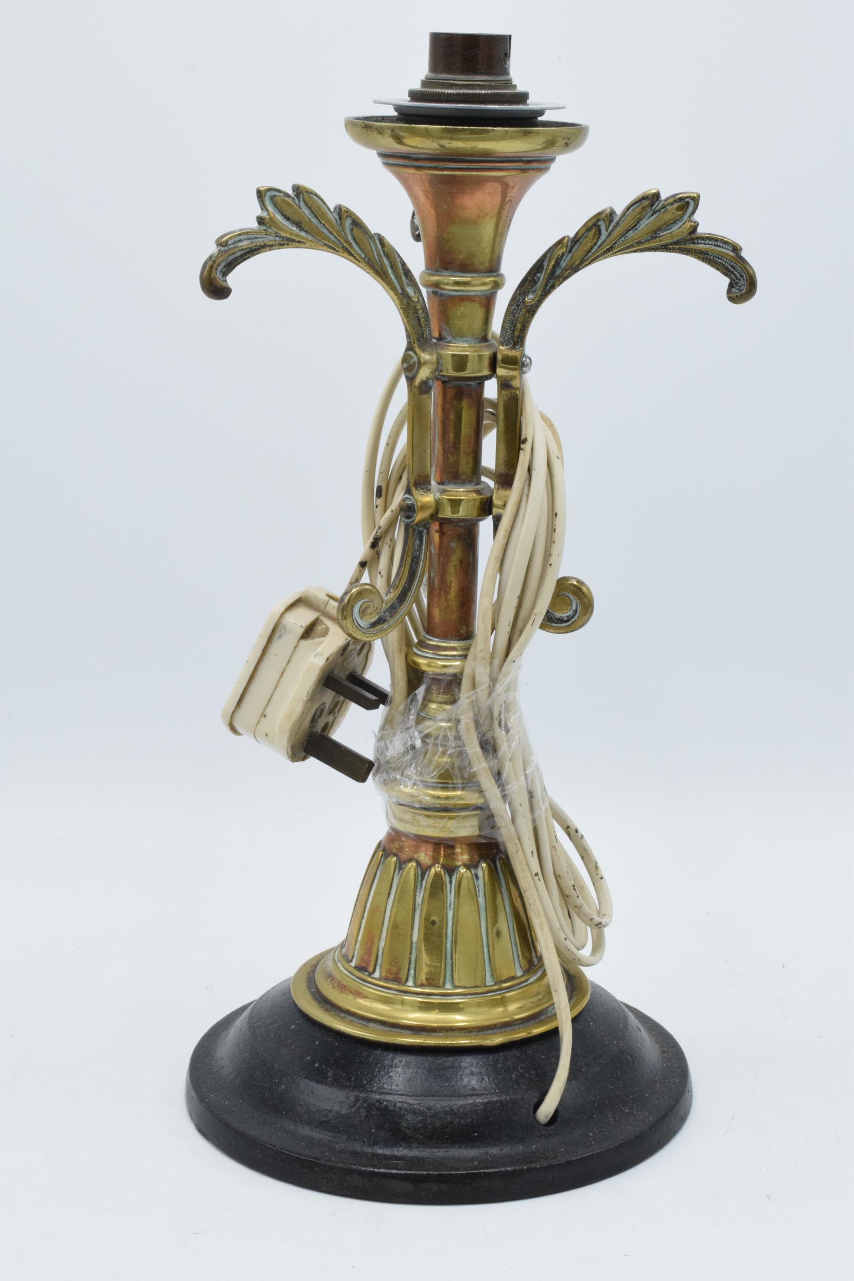 Early 20th century heavy cast brass and metal lamp base mounted onto heavy metal base, 34cm tall,