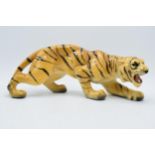 Mid 20th century chalk ware model of a crouching tiger, RD 896256, 35cm long. Some loss of paint /