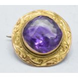 Victorian 9ct gold circular brooch set with an amethyst, 3.4 grams, 24mm.