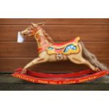 Fairground type painted rocking horse on stretchers style supports, made in fibreglass, 124cm