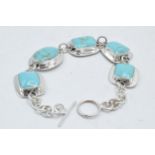 Silver ladies chunky bracelet set with turquoise colour insets, 19cm long.