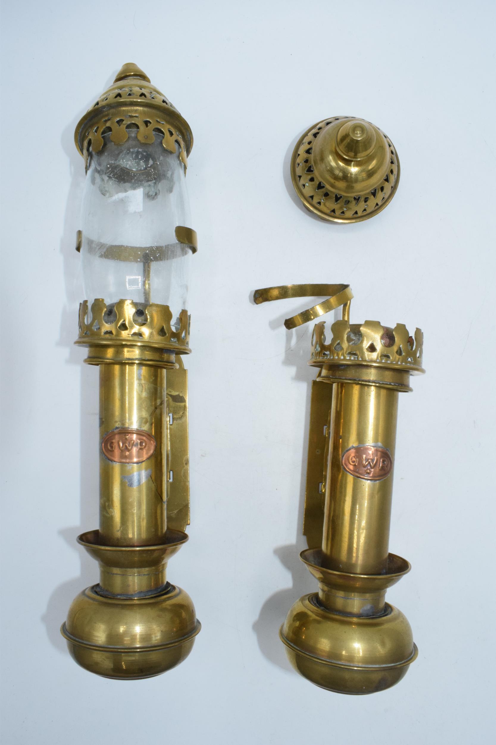 A pair of brass and copper 'GWR' candle sconces, one with glass shade, 32cm tall.