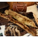 A quantity of vintage furs, stoles and other items together with a vintage leather handbag.