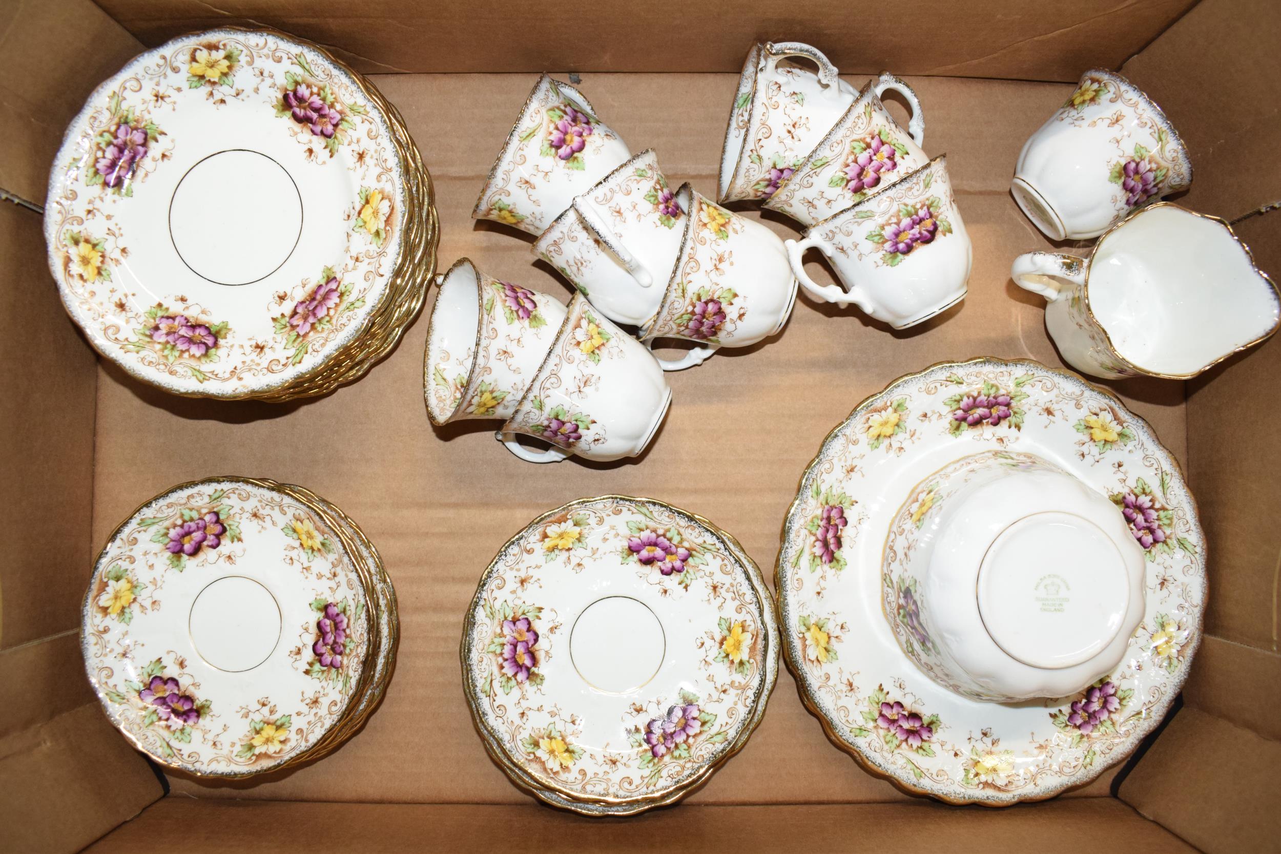 Melba China tea ware to include 9 cups, 12 saucers, 12 sides, milk and sugar with a cake plate. In