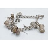 Silver charm bracelet with charms to include a boot, a tankard and others, 41.5 grams.