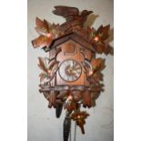 A German Black Forest traditional cuckoo clock complete with weights, chains and pendulum (no