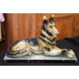 Art Deco plaster figure of a lying alsatian, 58cm long (some damages). Collection only.