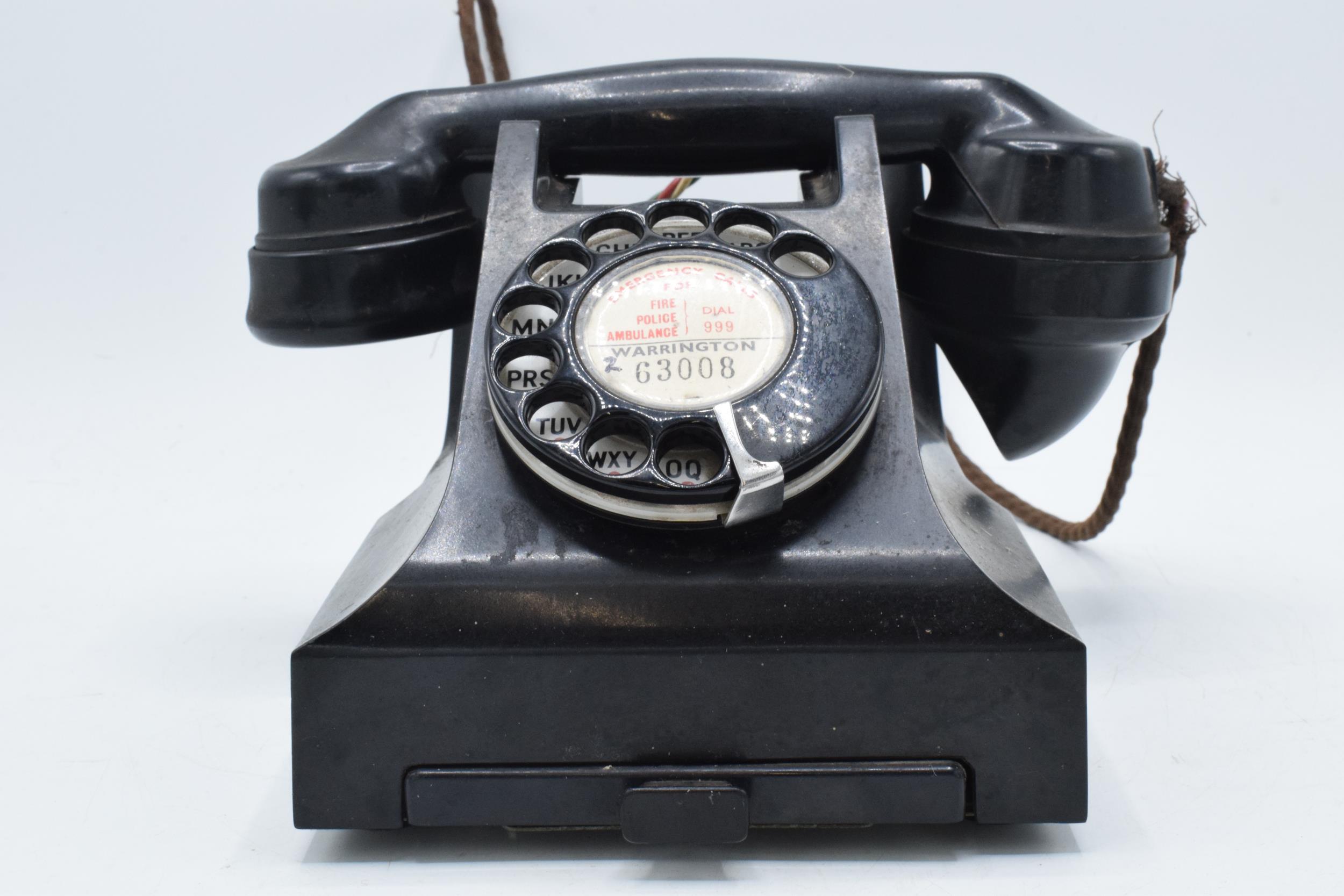 Vintage bakelite telephone and base 'Warrington', with wire. Sold as decorative.