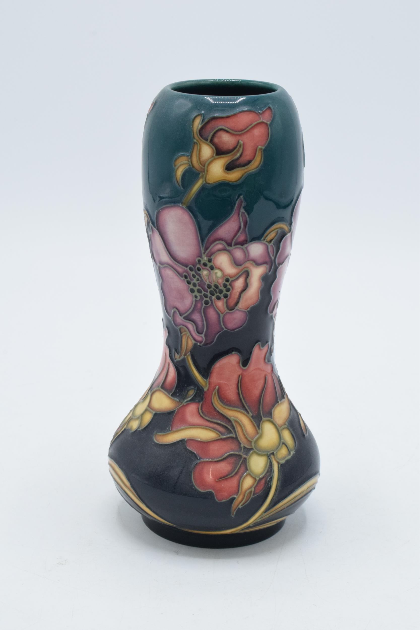 Moorcroft low shouldered gourd vase with floral patterns on blue background, 16cm tall, red dot