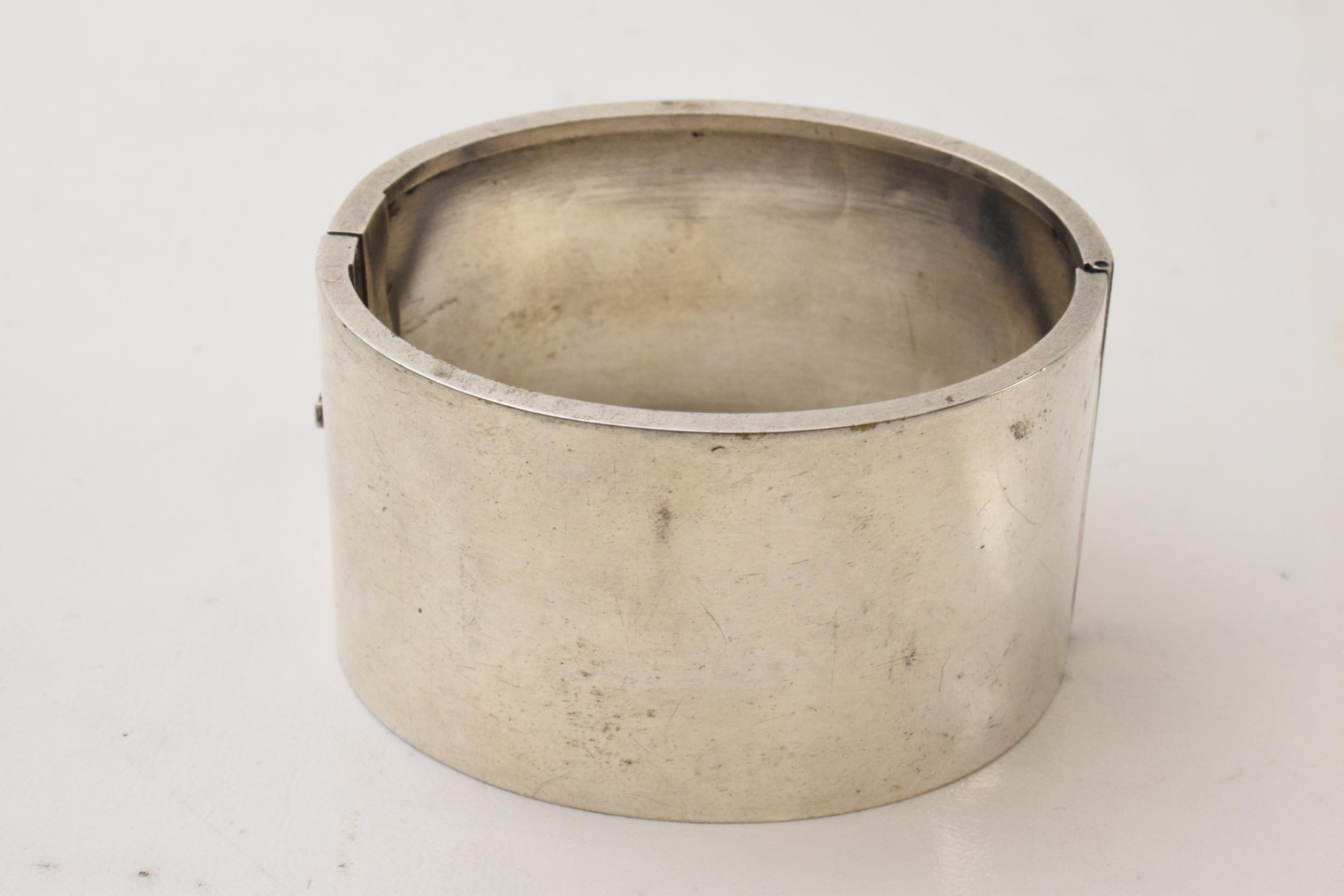 Silver engraved wide bangle with a girl skipping amongst foliage, 47.3 grams. No hallmarks but tests - Image 2 of 3