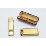 Cased cheroot holder with gold rim, a Dunhill gilt metal lighter with a Monic lighter (3).