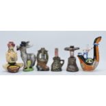 A collection of novelty decanters to include a Drioli snake charmer, a Donkey, stone effect