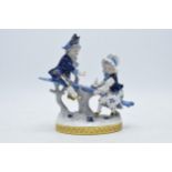 Volkstedt Rudolstadt figure of a pair of children sat on a branch, 16cm tall. In good condition with